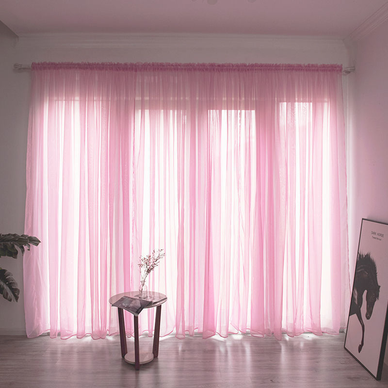 Modern solid color sheer gauze curtain on a balcony window filtering soft light