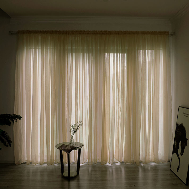 Modern solid color sheer gauze curtain on a balcony window filtering soft light