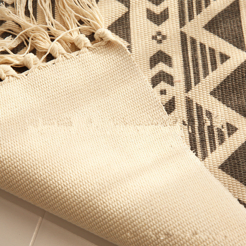 Woven tassel carpet placed in a cozy living room with neutral furniture and boho accents