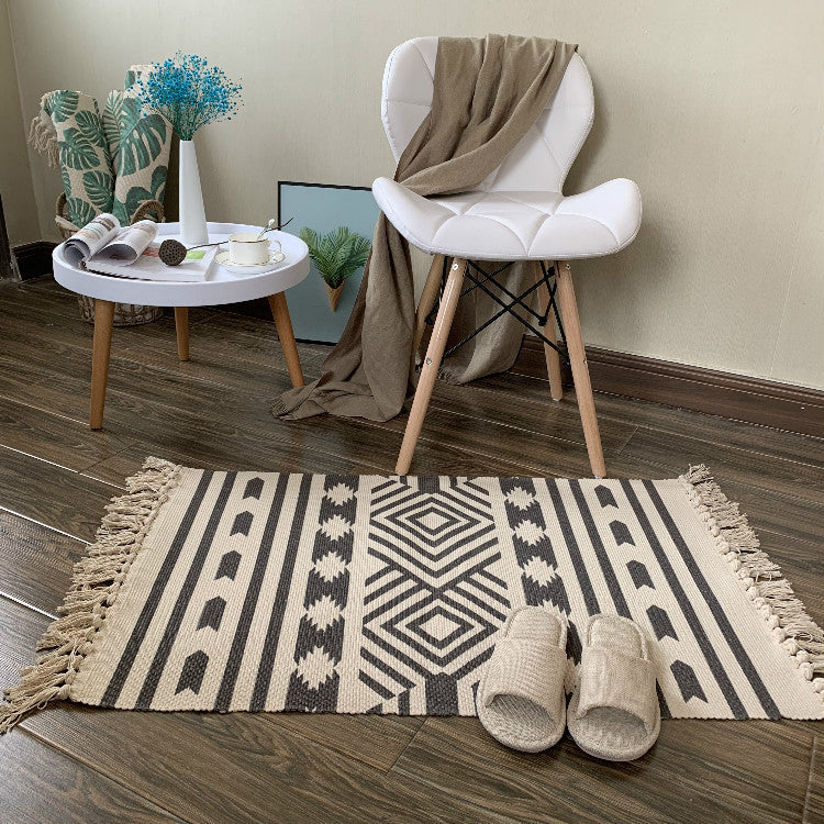 Woven tassel carpet placed in a cozy living room with neutral furniture and boho accents