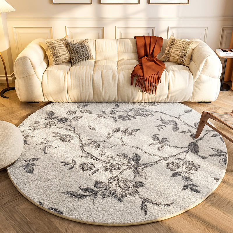 New round carpet placed in a modern living room under a coffee table with neutral décor