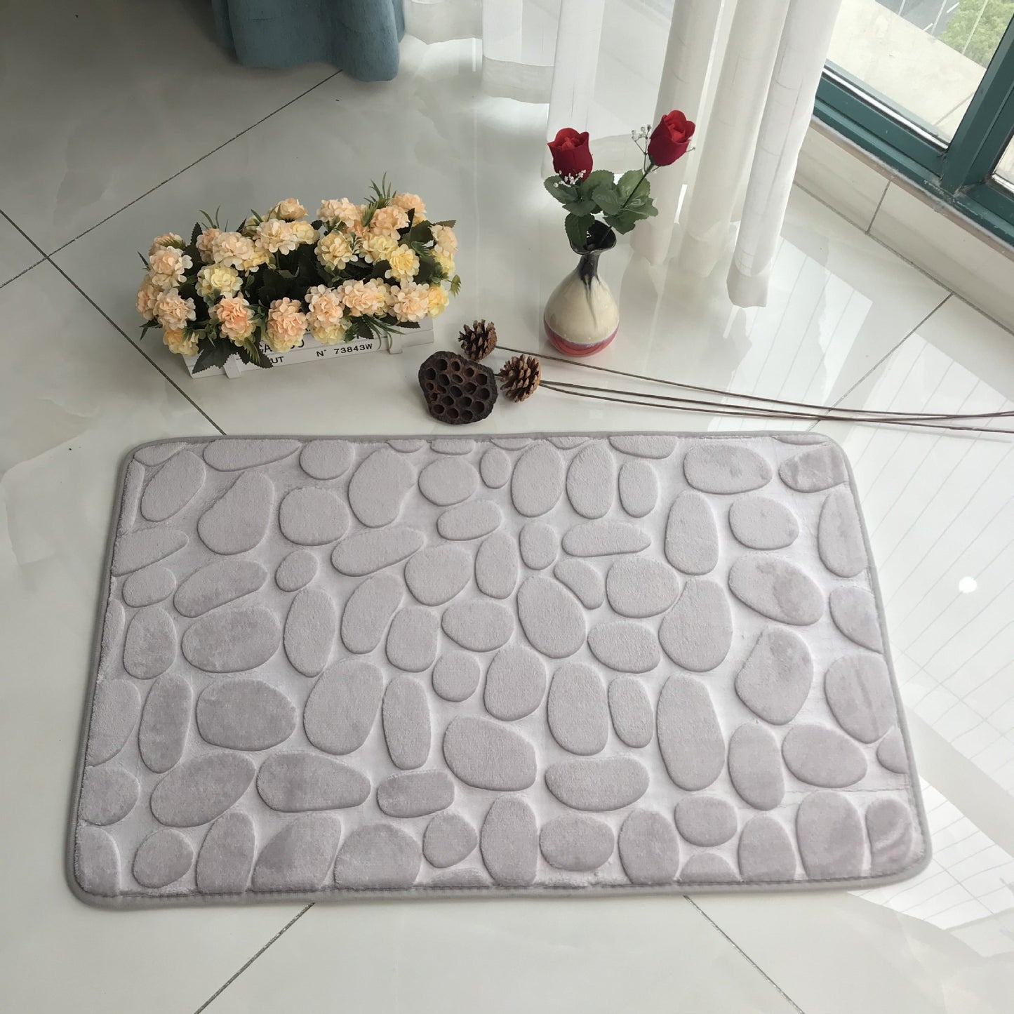 Pebble embossed carpet with 3D texture placed in a cozy bedroom near a bed and nightstand