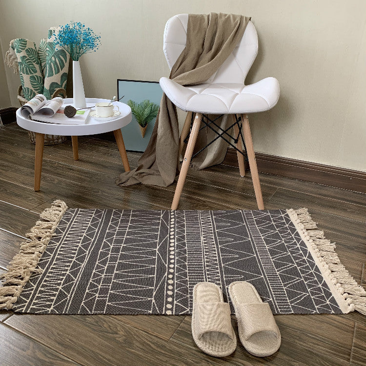 Woven tassel carpet placed in a cozy living room with neutral furniture and boho accents