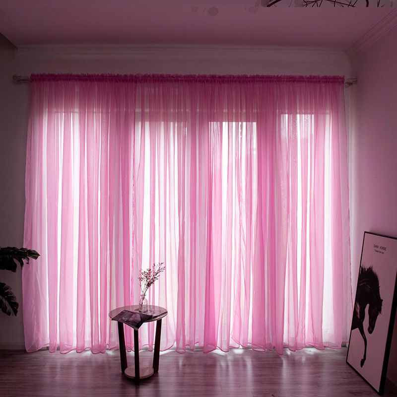 Modern solid color sheer gauze curtain on a balcony window filtering soft light