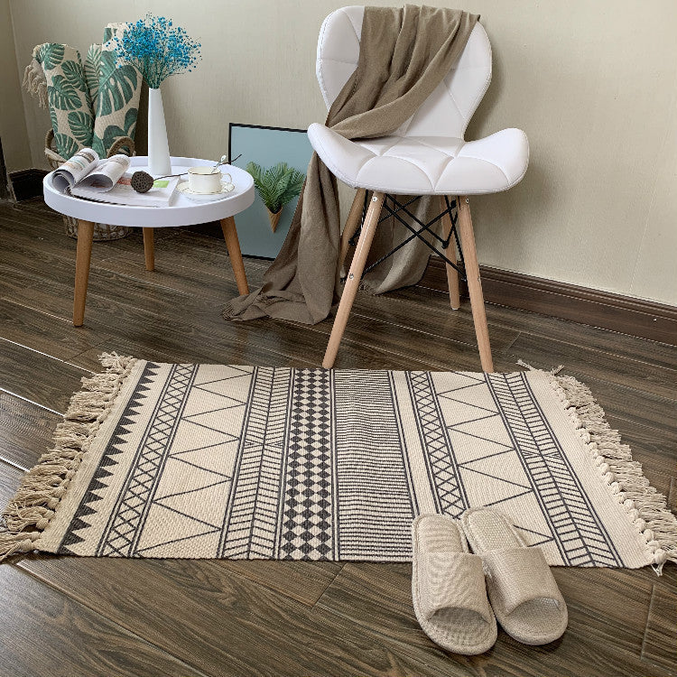 Woven tassel carpet placed in a cozy living room with neutral furniture and boho accents