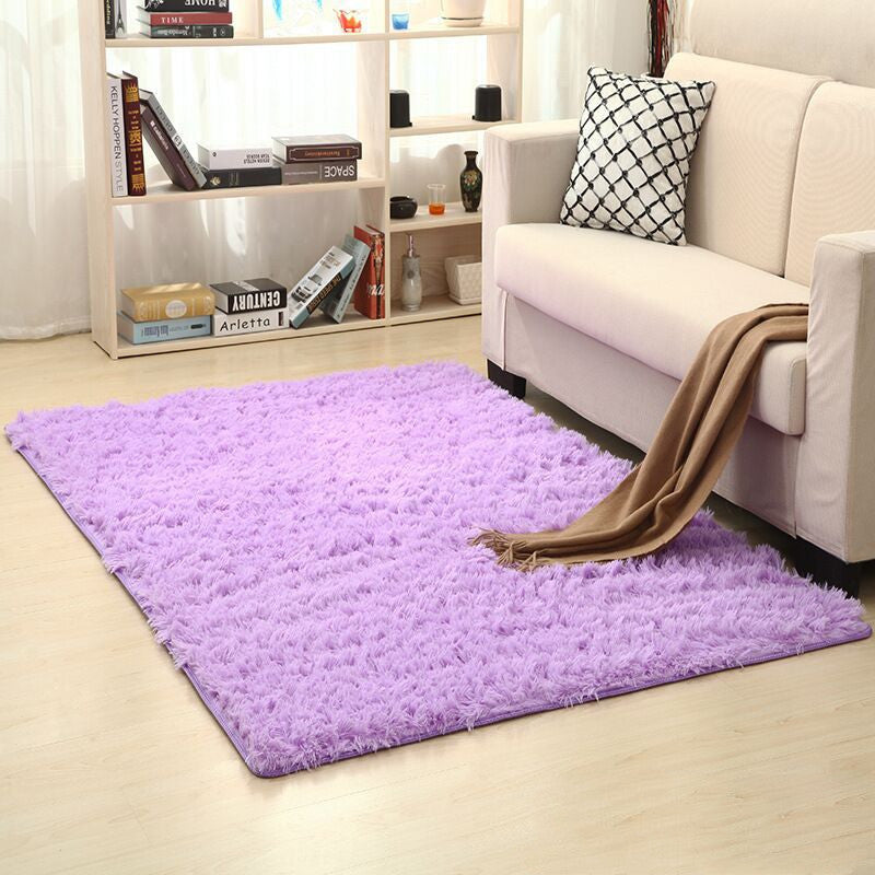 Soft carpet spread in a cozy living room with a sofa and coffee table beside a sunny bedroom corner