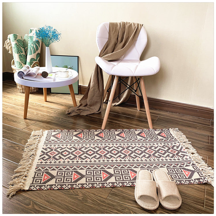Woven tassel carpet placed in a cozy living room with neutral furniture and boho accents
