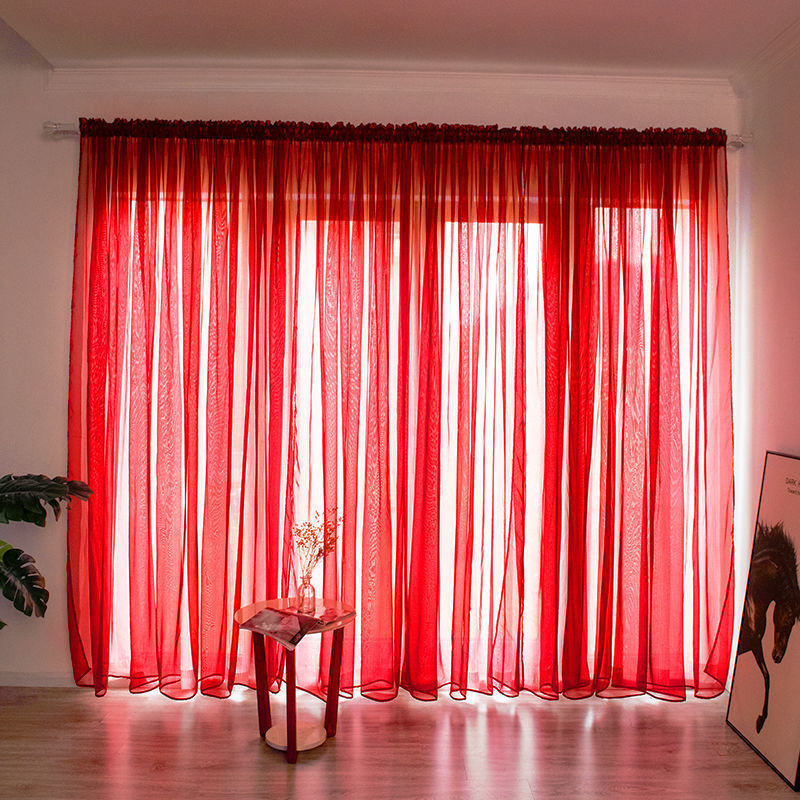 Modern solid color sheer gauze curtain on a balcony window filtering soft light