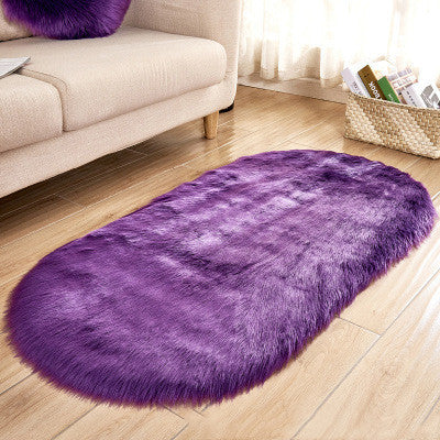 Oval wool-like carpet placed in a bedroom near the bed with cozy home décor