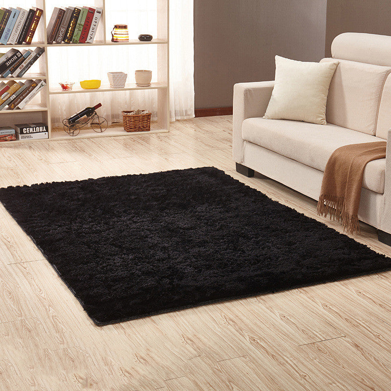 Soft carpet placed under a coffee table and beside a sofa in a cozy living room with neutral tones