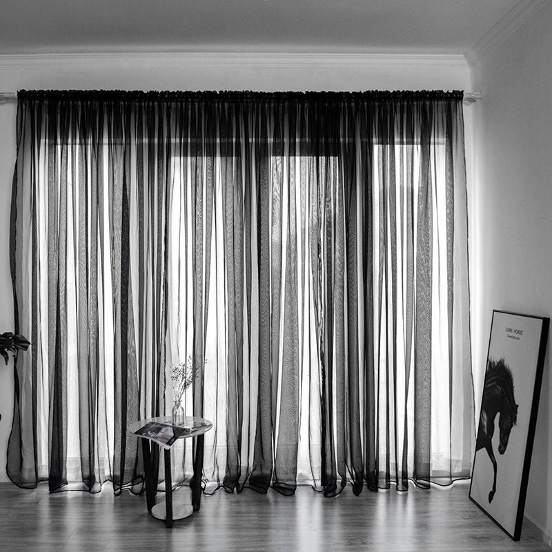 Modern solid color sheer gauze curtain on a balcony window filtering soft light
