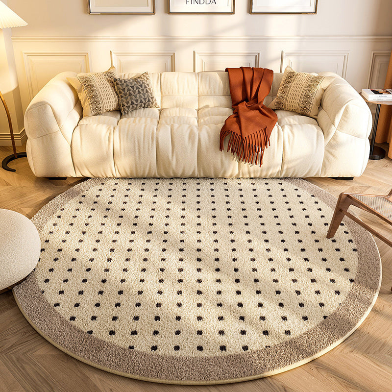 New round carpet placed in a modern living room under a coffee table with neutral décor