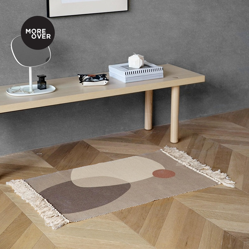 Small floor mat placed beside a living room sofa and coffee table in a modern, cozy space