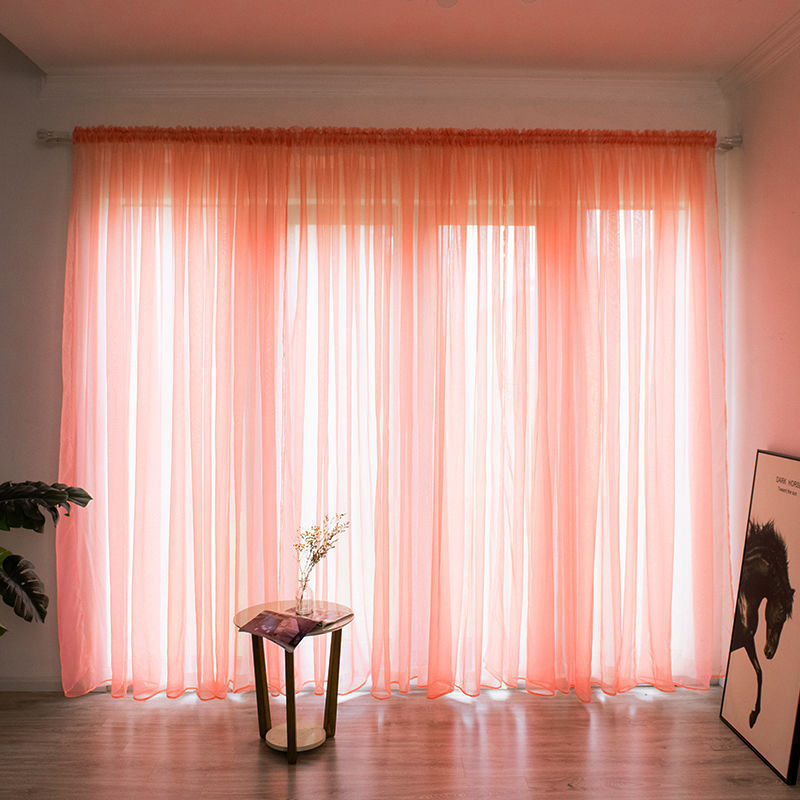 Modern solid color sheer gauze curtain on a balcony window filtering soft light