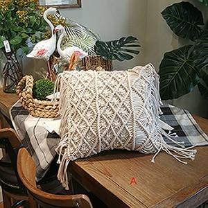 Hand-woven macrame cotton cushion cover on a rustic wooden bench with boho décor