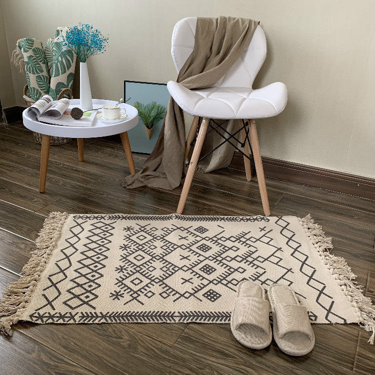 Woven tassel carpet placed in a cozy living room with neutral furniture and boho accents