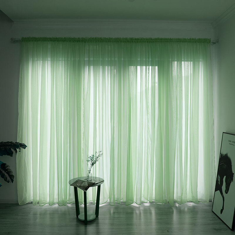 Modern solid color sheer gauze curtain on a balcony window filtering soft light