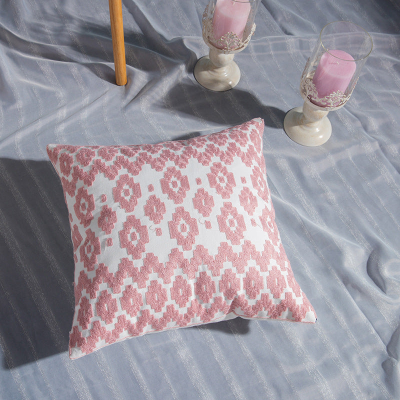 Geometric embroidered cotton pillowcase on a modern sofa with decorative cushions