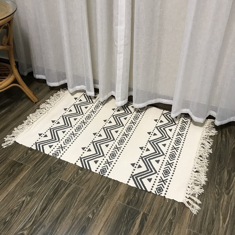 Woven tassel carpet placed in a cozy living room with neutral furniture and boho accents