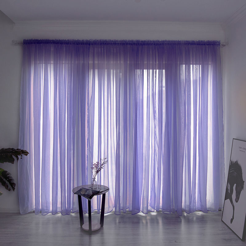 Modern solid color sheer gauze curtain on a balcony window filtering soft light