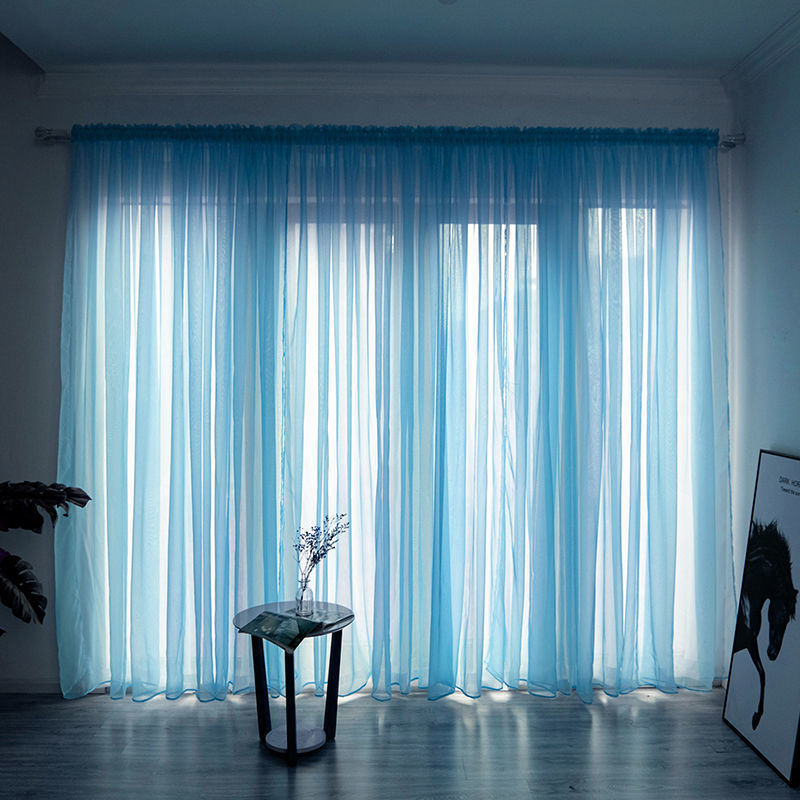 Modern solid color sheer gauze curtain on a balcony window filtering soft light