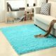 Soft carpet placed under a coffee table and beside a sofa in a cozy living room with neutral tones