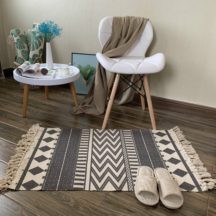 Woven tassel carpet placed in a cozy living room with neutral furniture and boho accents