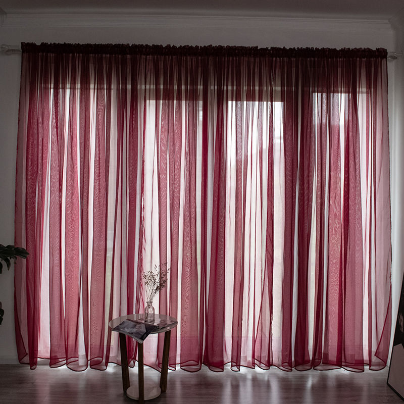 Modern solid color sheer gauze curtain on a balcony window filtering soft light