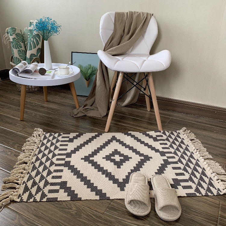 Woven tassel carpet placed in a cozy living room with neutral furniture and boho accents