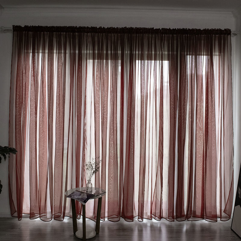 Modern solid color sheer gauze curtain on a balcony window filtering soft light