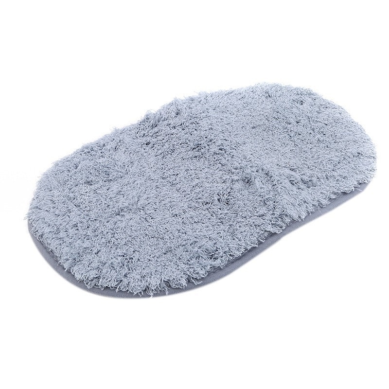 Oval-shaped absorbent carpet in a modern living room with light furniture and natural lighting