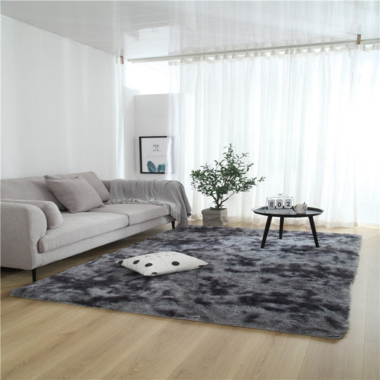Tie-dye gradient rug with long wool texture beside a bed and end table in a modern bedroom