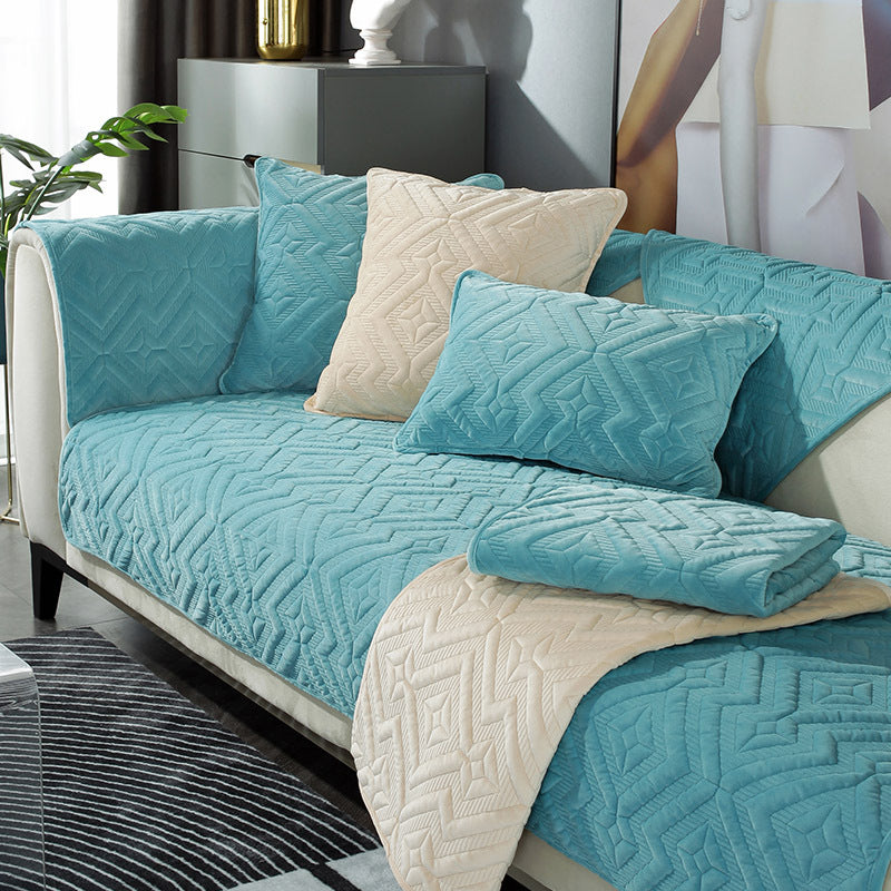 Black plush winter sofa cushion on a leather sofa with thick quilted texture