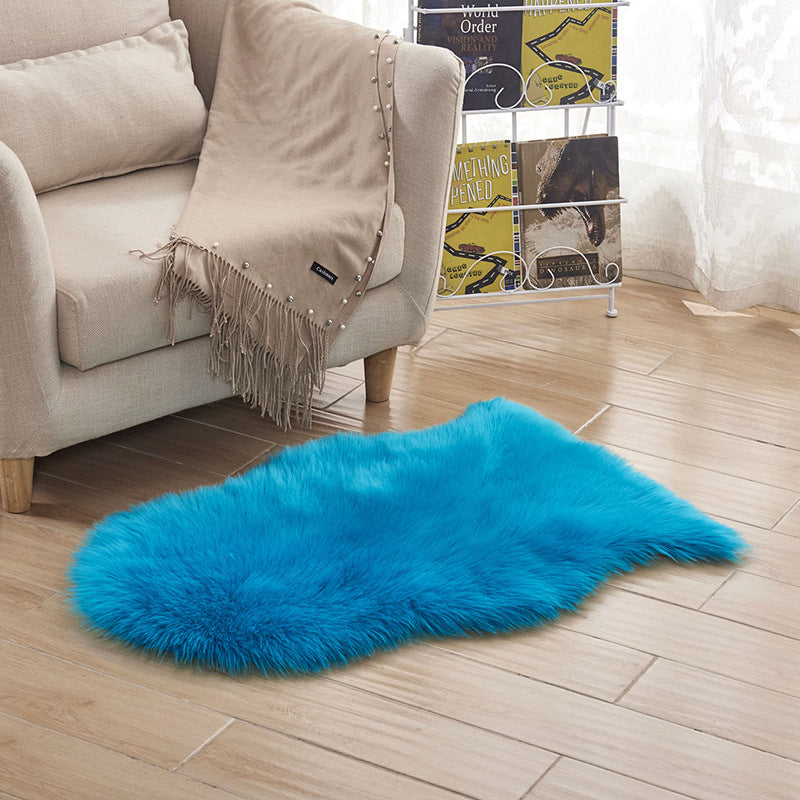 Plush carpet floor mat placed in a bedroom near the bed on a wooden floor

