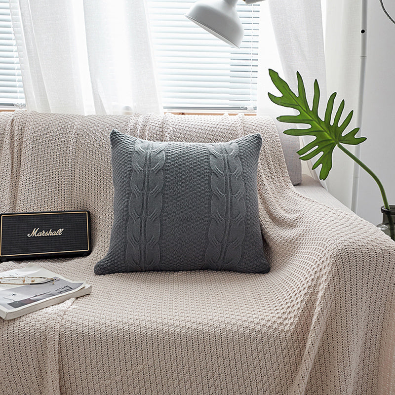 Natural wool pillow placed on a bed with neutral, minimalist bedding


