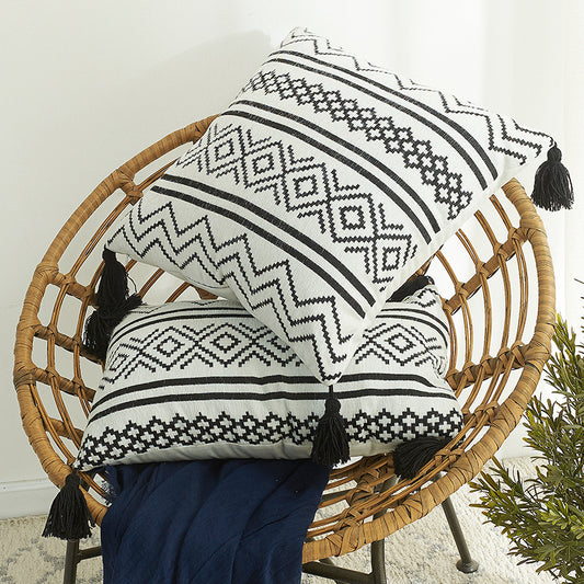 Nordic Moroccan chenille geometric throw pillow with tassels on a modern sofa

