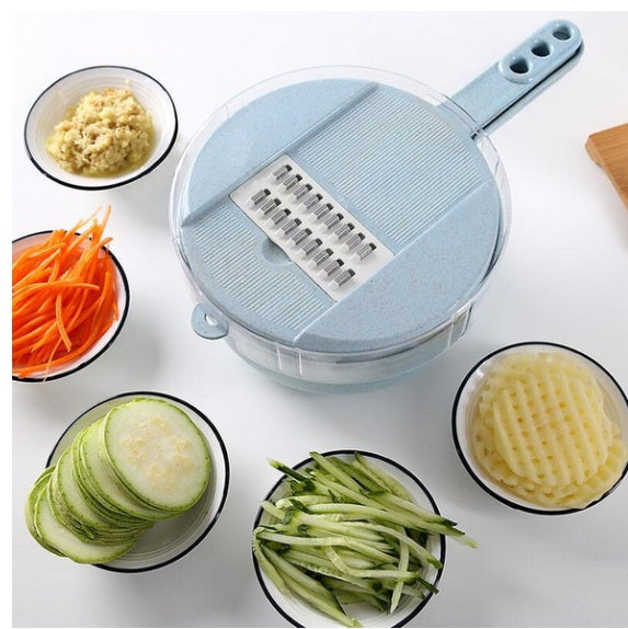 Vegetable slicer with sliced vegetables on a white background