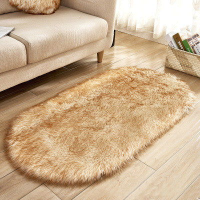 Oval wool-like carpet placed in a bedroom near the bed with cozy home décor

