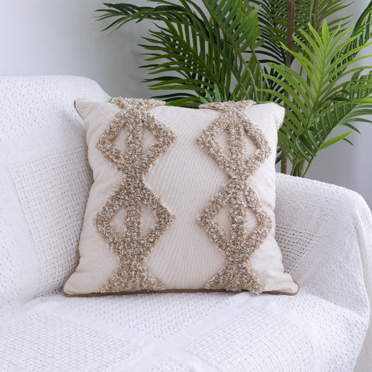 Tufted Moroccan fringed waist pillow on a boho-style sofa with cozy textures

