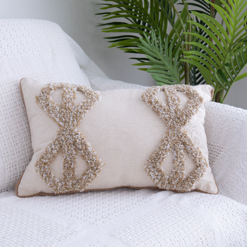 Tufted Moroccan fringed waist pillow on a boho-style sofa with cozy textures

