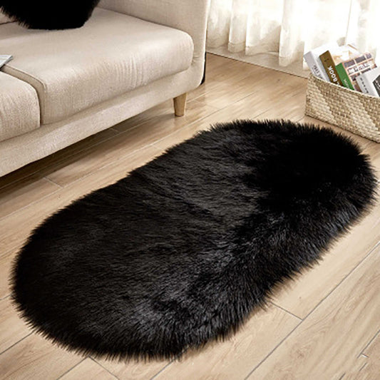 Oval wool-like carpet placed in a bedroom near the bed with cozy home décor

