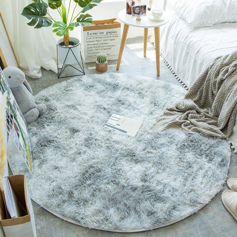 Nordic round silk wool carpet placed in a minimalist living room with natural light and cozy furniture

