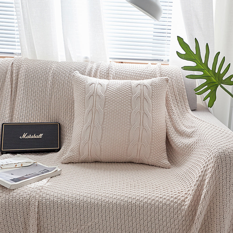Natural wool pillow placed on a bed with neutral, minimalist bedding

