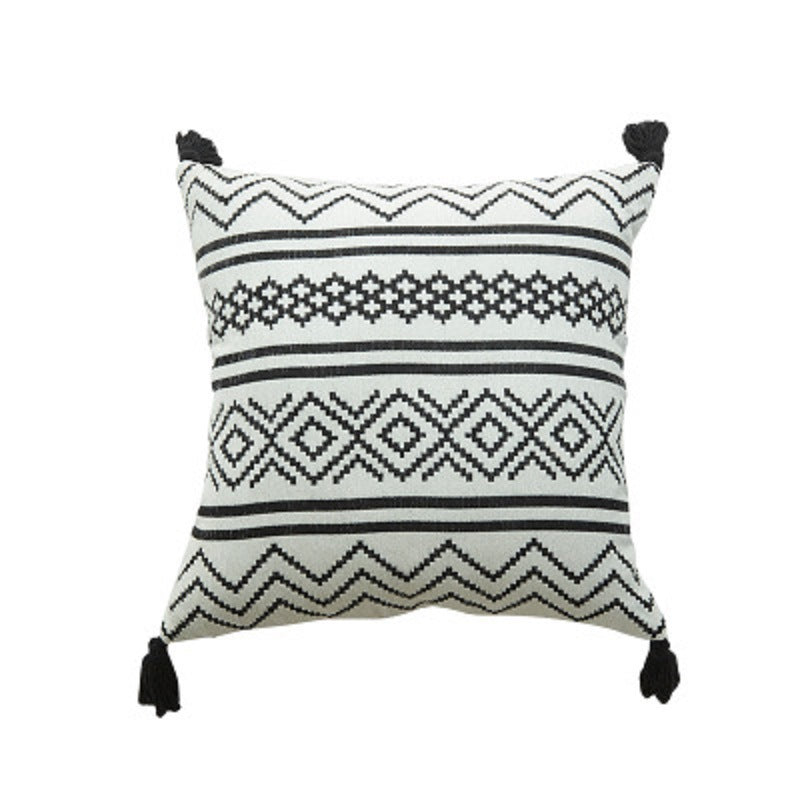 Nordic Moroccan chenille geometric throw pillow with tassels on a modern sofa

