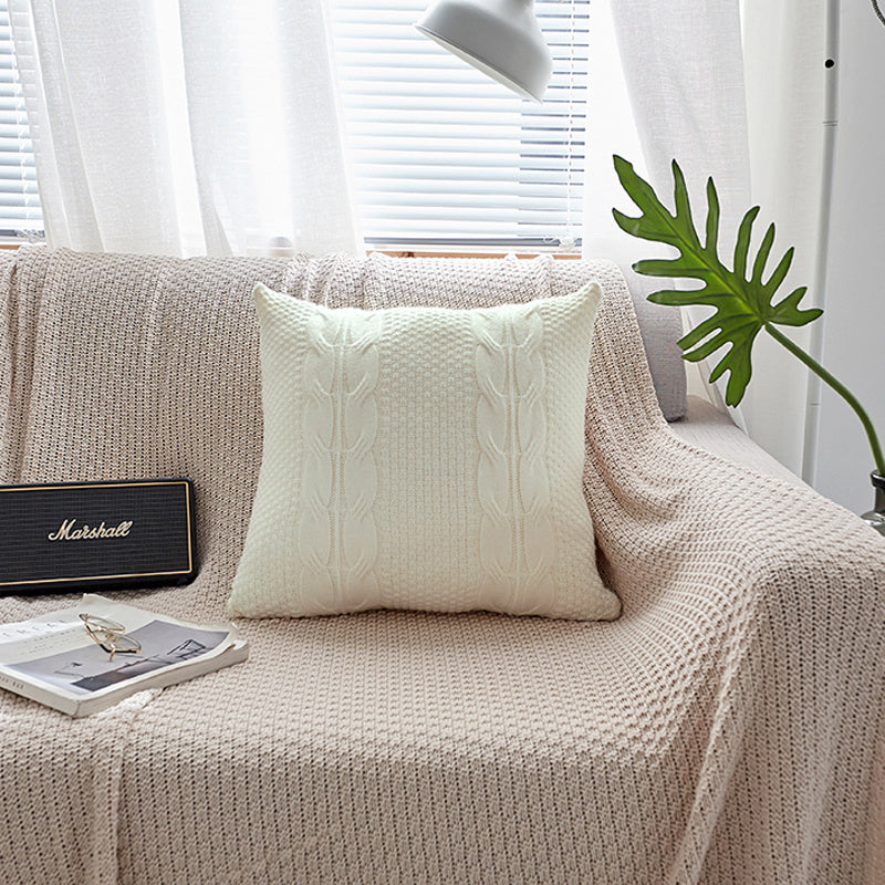 Natural wool pillow placed on a bed with neutral, minimalist bedding

