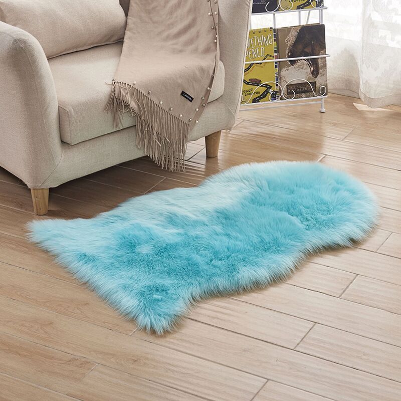 Plush carpet floor mat placed in a bedroom near the bed on a wooden floor

