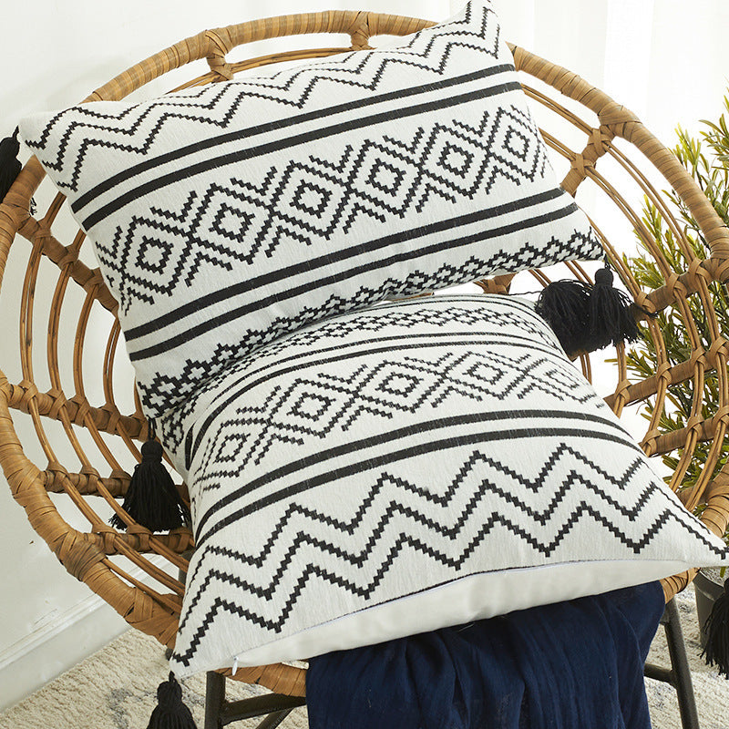 Nordic Moroccan chenille geometric throw pillow with tassels on a modern sofa

