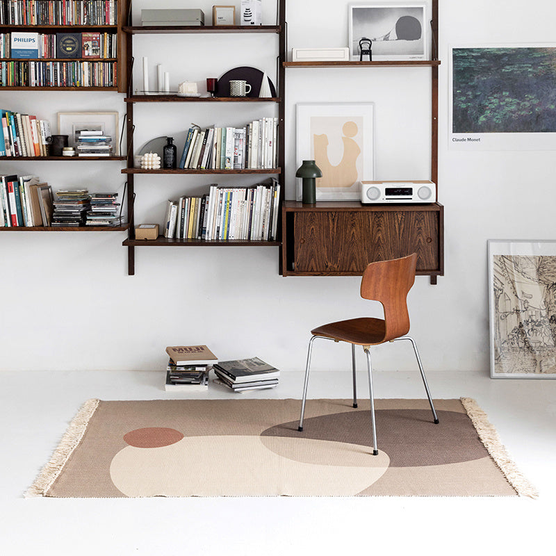 Small floor mat placed beside a living room sofa and coffee table in a modern, cozy space

