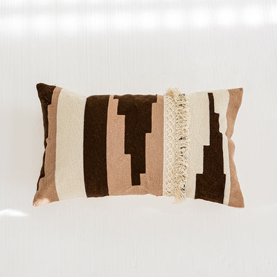 Nordic-style decorative cushion on a minimalist sofa with neutral tones

