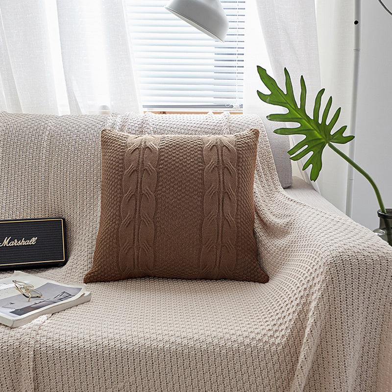 Natural wool pillow placed on a bed with neutral, minimalist bedding

